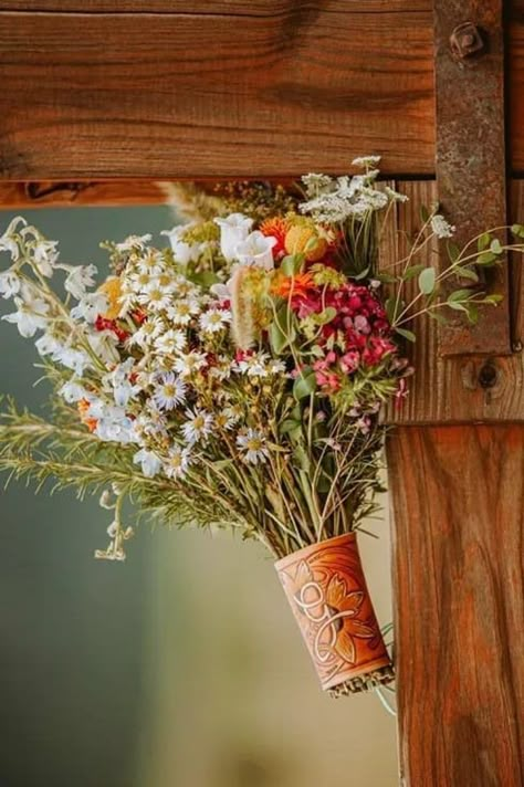 Choose a more rustic-style bouquet for your western wedding, with wildflowers to boot. To take it one step further? A leather wrap to hold your blooms in place makes for such a charming touch. Find more western wedding ideas we love at the link. // Photo: Whiskey Jain Leather Company Western Wedding Flower Bouquet, Whimsical Western Wedding, Bright Western Wedding, Spring Wedding Western, Western Wedding Spring, Western Wedding Alter, Western Wildflower Wedding, Western Flower Arrangements, Summer Western Wedding