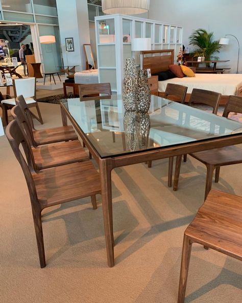 The Lisse Dining Collection is the perfect marriage of modern and classic design. Crafted from solid walnut, this features graceful curvature with its molded and sculptural lines. A glass top brings a modern sensibility to the table, while the solid base provides the perfect foundation for this finely crafted piece. Photo by: PerLora Furniture @perlorahome Glass On Wood Table, Wood Base Glass Top Dining Table, Dining Table Glass, Big Dining Table, Wood Dining Table Modern, The Perfect Marriage, Small Room Design Bedroom, Round Dining Table Sets, Dining Table In Living Room