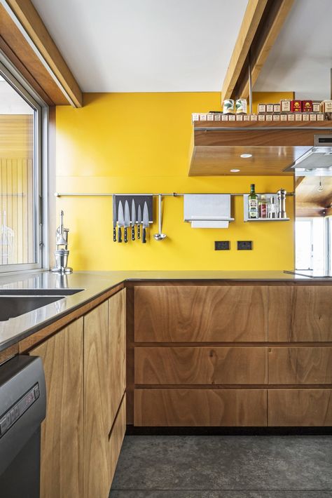 Photo 5 of 9 in This Bunker-Like Home in New Zealand Fights Back Against Howling Winds Off Lake Wanaka - Dwell Kitchen Yellow Black, Yellow Kitchen Splashback, Kitchens With Yellow Walls, Yellow Kitchen Walls With Wood Cabinets, New Zealand Interior Design, Yellow And Wood Kitchen, Cabinet Dishwasher, Yellow Kitchen Walls, Kitchen Yellow