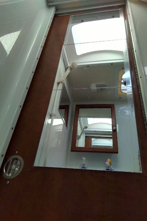 Full-Height Bathroom Mirror In A Camper - Truck Camper Magazine Rv Mirror Ideas, Camper Mirror Ideas, Moving Mirror Bathroom, Camper Shower Doors, Camping Renovations, Rv Bathroom Mirror, Framing Bathroom Mirror With Command Strips, Camper Modifications, Kevin G