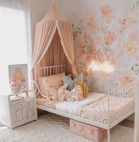 Stephanie from The Vara Tribe on Instagram has done it again with this dreamy pink girl's bedroom. With pink floral wallpaper, a gorgeous pink magnolia botanical garden canopy from Spinkie, butterfly wall decals from Little Custom Creations, LED neon name from Letterly and Mustard shell cushion from Peppermint Tree Creations, it's not hard to see why this pink bedroom is so popular. Click on the pin to see our full interview with Stephanie, and full list of materials to help you get the look! Girls Bedroom Paint, Girls Room Colors, Ideas Habitaciones, Pink Bedroom For Girls, Toddler Bedroom Girl, Big Girl Bedrooms, Toddler Girl Room