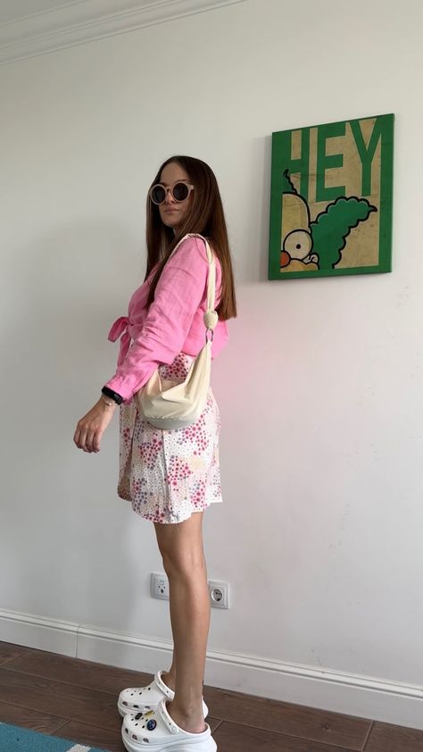 Sharing my outfits: Outfit for Barbie movie 💕 Pink linen shirt, floral mini skirt, Crocs Bae Clog, crossbody bag, round glasses #ootd #ootdfashion #streetstyle #fashion #lookoftheday #outfits #outfitideas #barbie #style #stylish #styleblogger #styleideas Crocs With Skirt Outfit, Skirt With Crocs, Crocs Pink Outfit, Crush Crocs Outfit, Orange Crocs Outfit, Crocs Siren Clogs Outfit, Crocs Mega Crush Clog Outfit, Outfit For Barbie Movie, Crocs Outfits Women