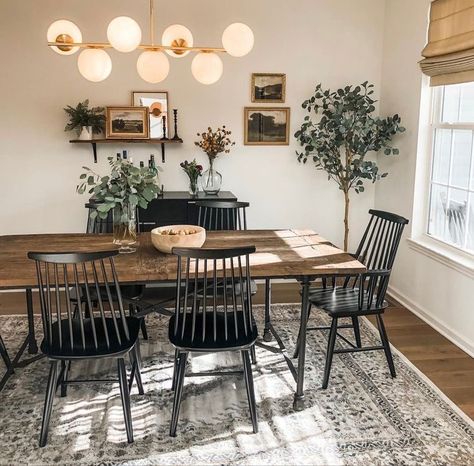 Small Dining Room Ideas Industrial, Black Cream Brass Living Room, Modern Boho Chic Dining Room, Dark Wood Floors In Dining Room, Dining Chairs Mixed Styles, Brown Wood Table With Black Chairs, Dinning Room Table With Dark Wood Floors, Shelf Behind Dining Table, Simplistic Dining Room