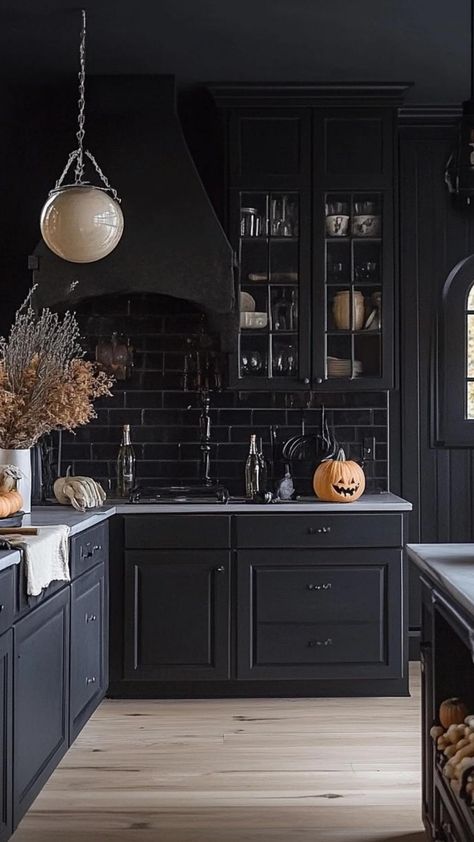 Unleash your inner witch in the kitchen with Halloween decor that casts a spellbinding ambiance. Adorn countertops with miniature pumpkins, place haunted house cookie jars on shelves, and drape cobweb runners across the island. Hang gothic-inspired artwork and replace everyday curtains with shadowy alternatives. Let your kitchen become a cauldron of creativity, where Halloween magic simmers alongside your culinary creations. Decorating Top Of Kitchen Cabinets, Feminine Era, Top Of Kitchen Cabinets, Gothic Kitchen, Spooky Kitchen, Chic Kitchen Decor, Inner Witch, Bloxburg Ideas, Halloween Kitchen