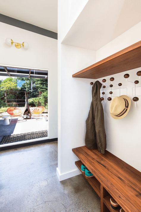 Serving as a transitional area to the back yard, the mud room’s custom shelving echoes the walnut touches found throughout the kitchen. Vct Flooring, Mid Century Renovation, Mid Century Modern Renovation, Mod Furniture, Mudroom Entryway, Blue Backsplash, Modern Renovation, Custom Shelving, Mudroom Design