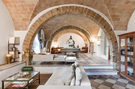 10 Dreamy Italian Villas You Can Rent for an Idyllic Getaway - Dwell Brick Archway, Cement Tile Floor, Tuscan Farmhouse, Clad Home, Limestone Wall, Tuscan Villa, Italian Villa, Brick Flooring, Comfortable Bedroom