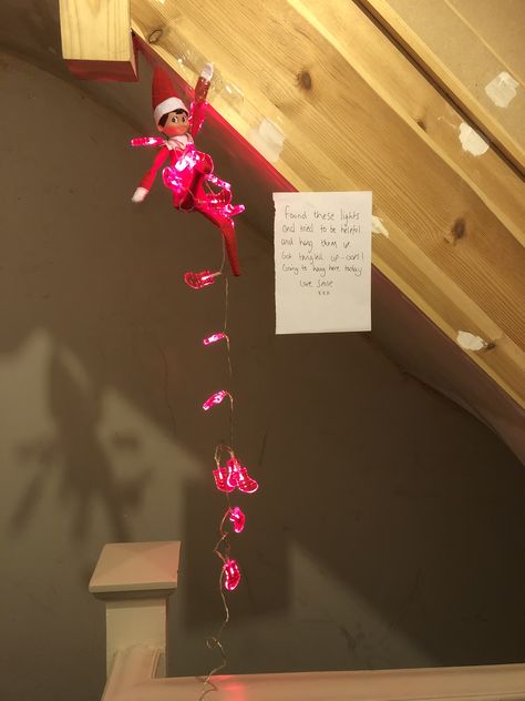 Elf gets tangled up trying to be helpful. Elf Hanging From Christmas Lights, Elf Tangled In Lights, Elf Wrapped In Lights, First Elf On The Shelf, Shelf Lighting, Shelf Ideas, On The Shelf, The Elf, String Lights