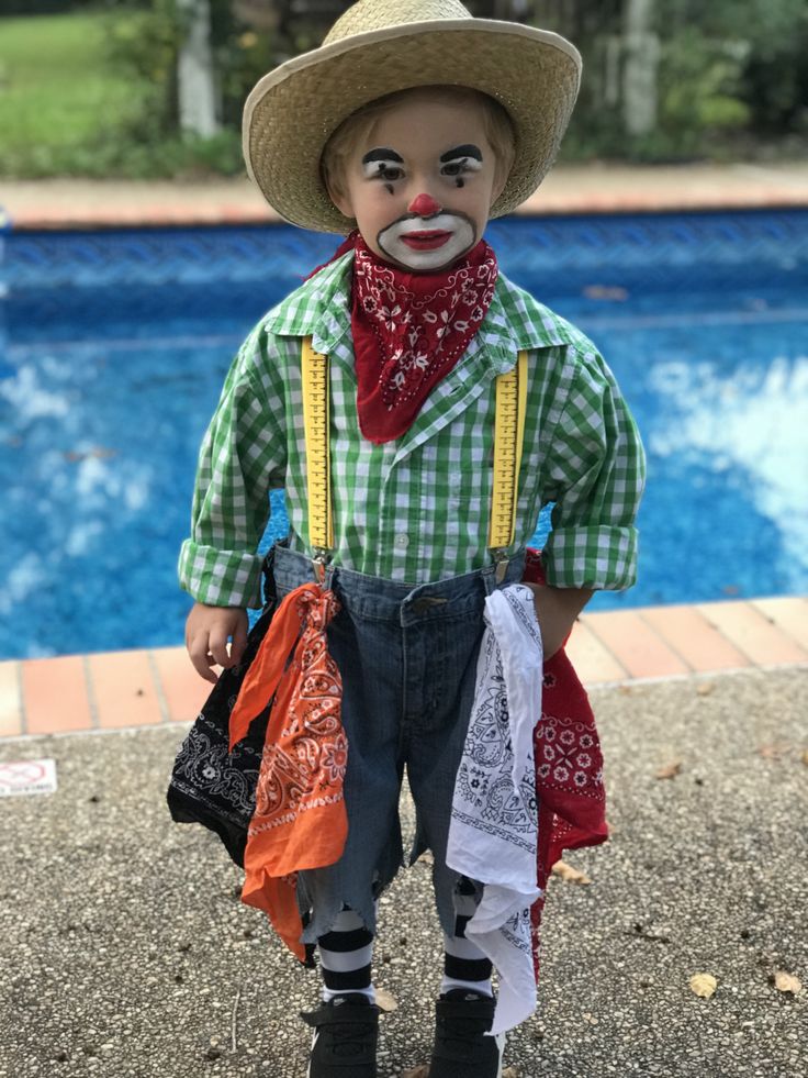 a doll is standing next to a pool wearing a cowboy hat and holding two bags