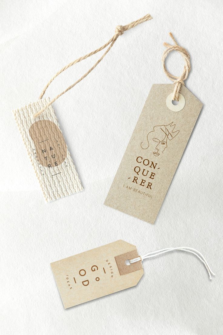 two tags are attached to twine string on a white surface with some type of paper