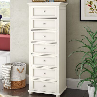 a white chest of drawers in a living room