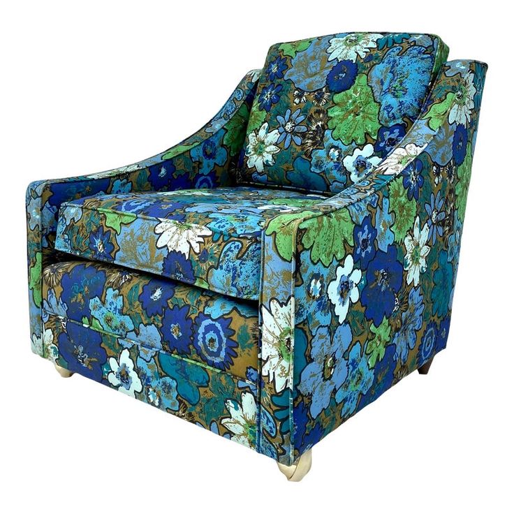 an upholstered chair with blue and green flowers on it