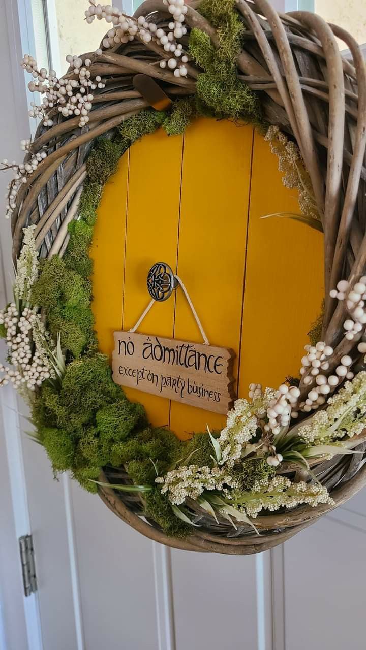 a wreath hanging on the front door with a sign that says no romance