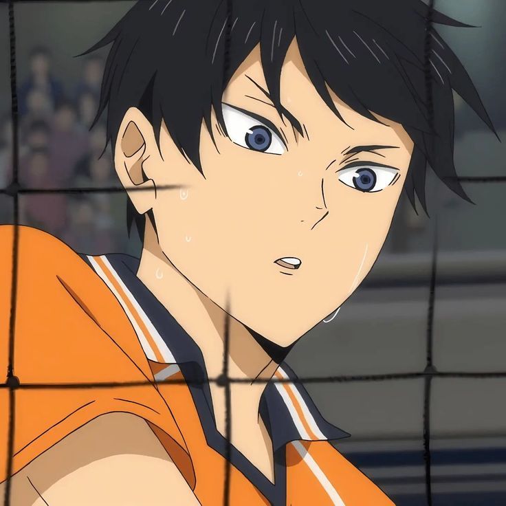 an anime character with black hair and blue eyes looks at the camera from behind a wire fence