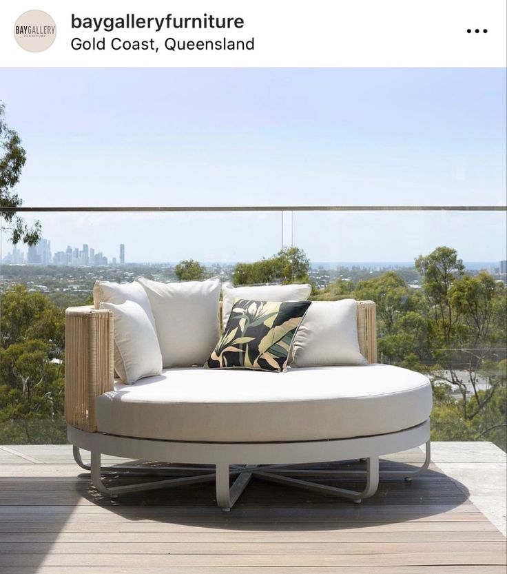 a white couch sitting on top of a wooden deck