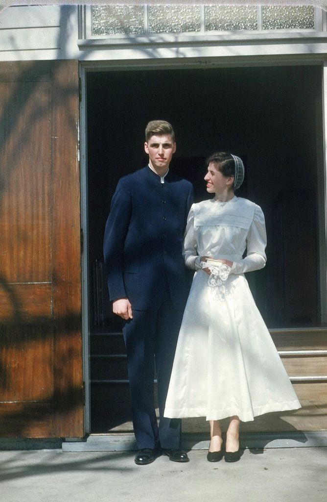 a man and woman standing in front of an open door