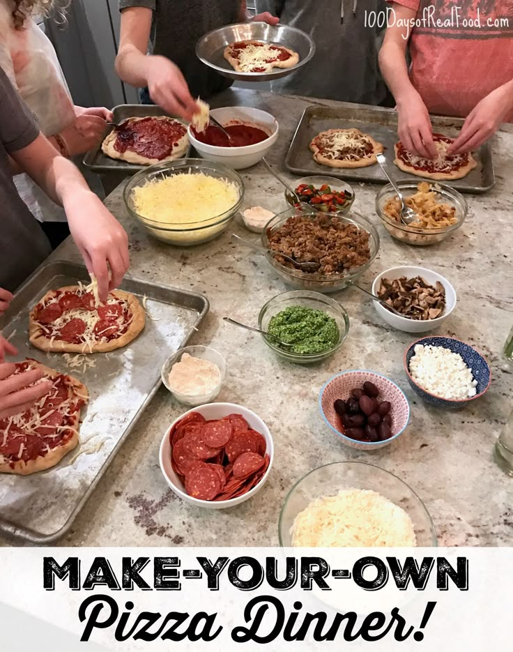 several people are making pizzas on the kitchen counter top, with toppings and condiments