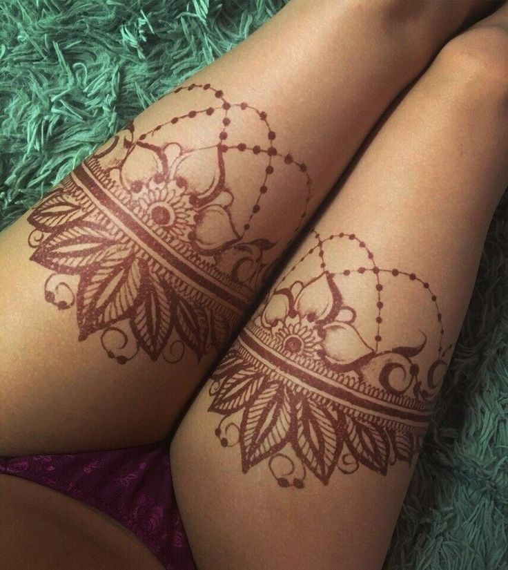 two legs with henna tattoos on them