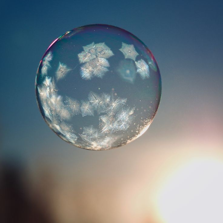 a bubble with snow flakes floating in the air