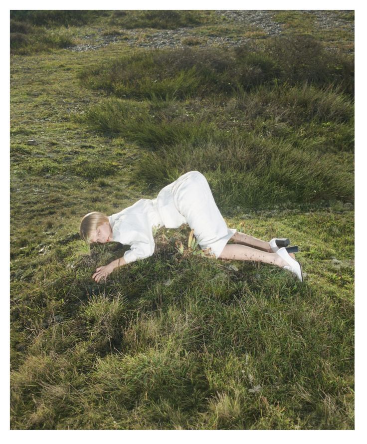 a person laying on the ground in a field