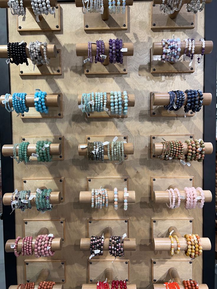 a display with bracelets and necklaces on wooden racks