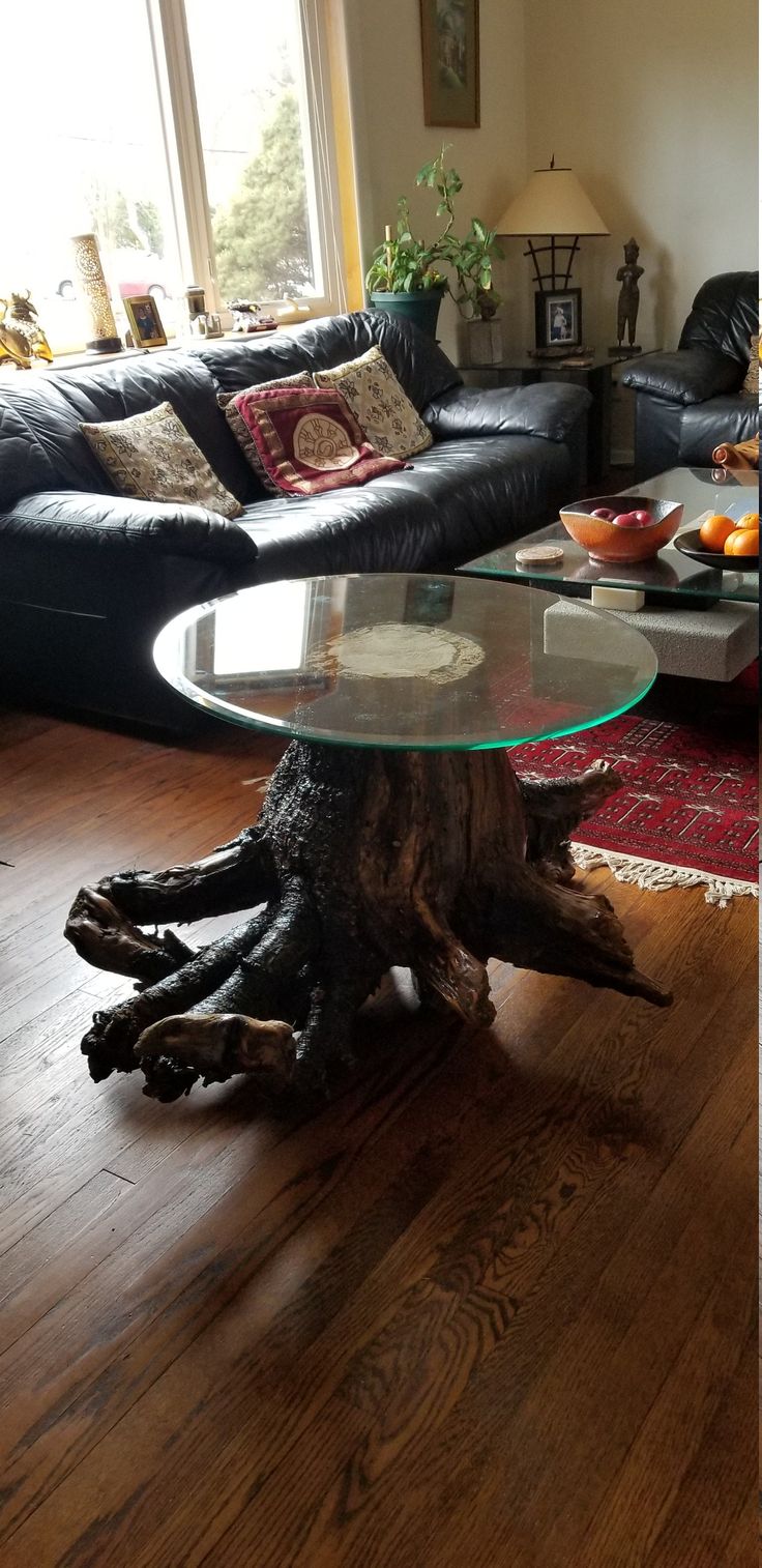 a living room filled with furniture and a tree stump table