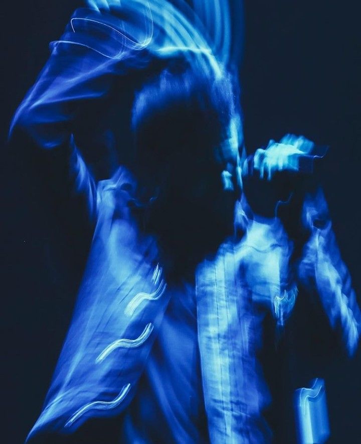 a blurry image of a man dancing in the dark