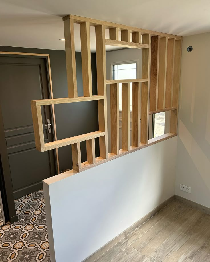 an empty room with wooden shelves on the wall