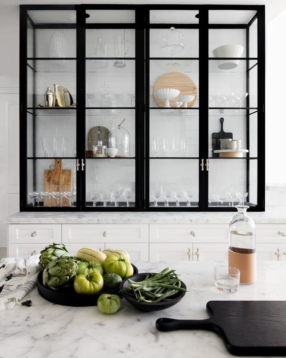 the instagram page on instagram com shows an image of a kitchen with black cabinets and white marble countertops