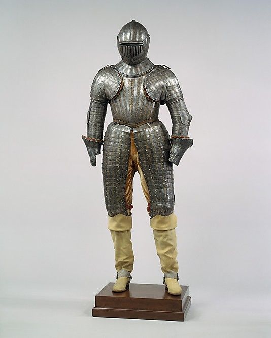 a statue of a man in armor on a wooden base