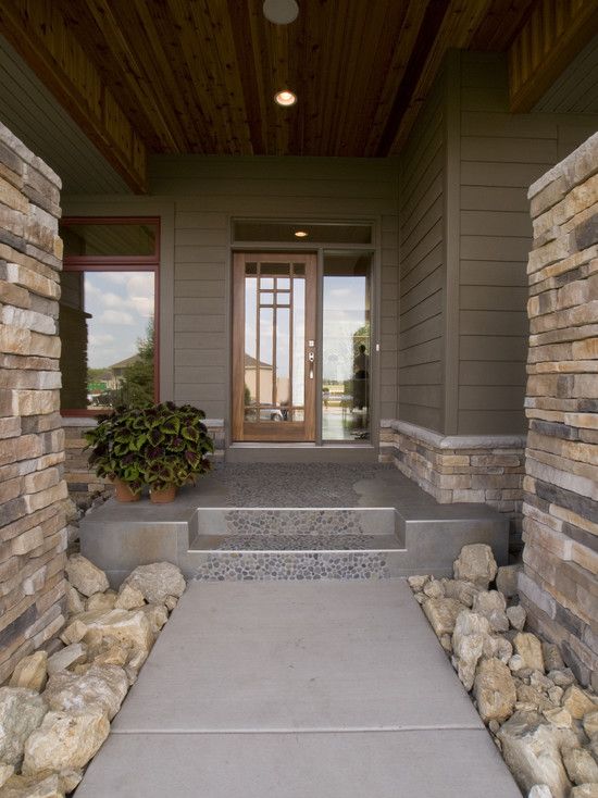 an entry way with stone steps leading to the front door