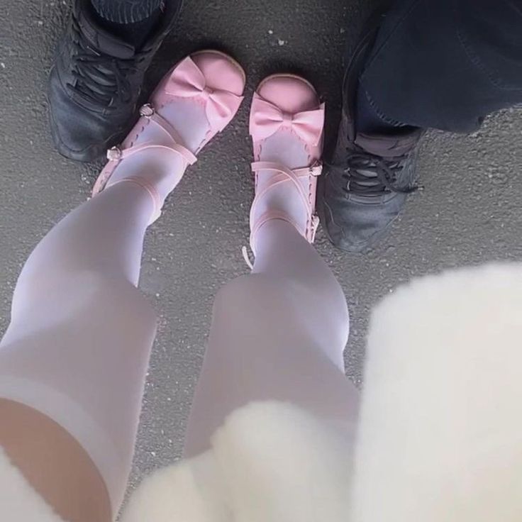 two people wearing pink shoes standing next to each other