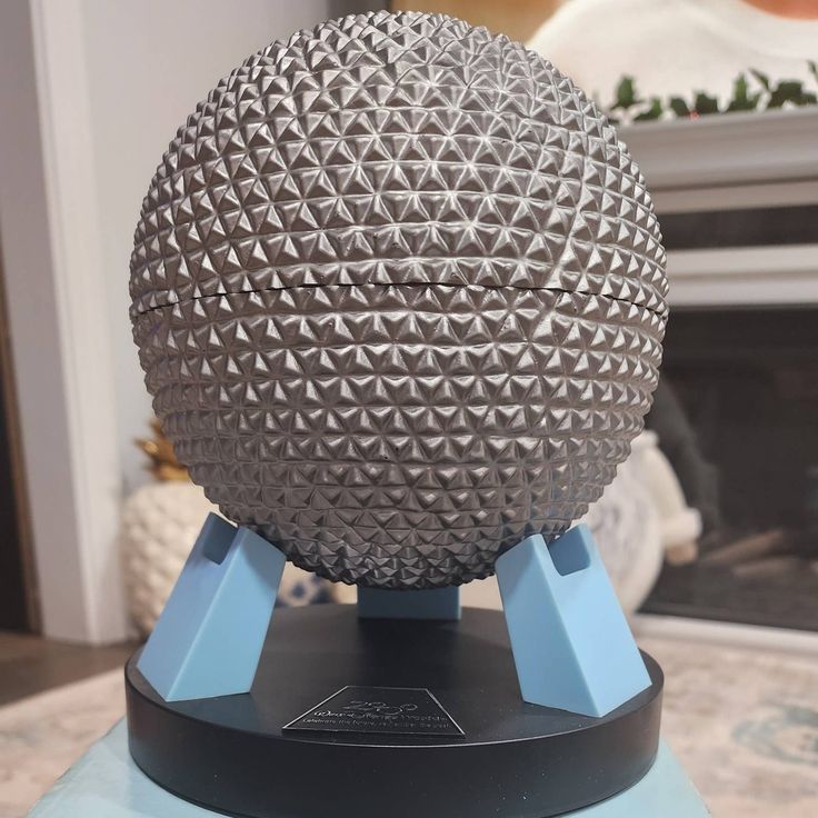 a metal ball sitting on top of a blue stand