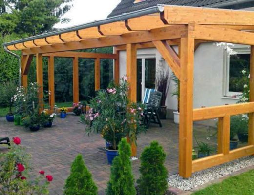 a patio covered in wooden pergols and potted plants next to a house