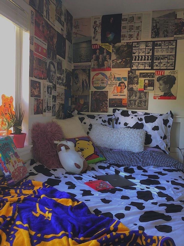 a bed with pillows and pictures on the wall above it, along with other items