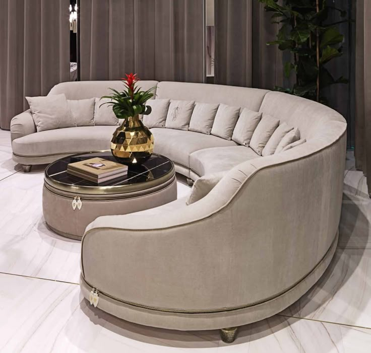 a living room filled with furniture and a round table in front of a curtained window