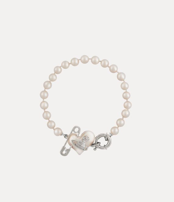 Pearls remain an essential element of the house’s iconography, evoking both a sense of luxury and rebellion. This season's Orietta Pearl bracelet features a row of glass-based Swarovski pearls, adorned with the iconic asymmetric heart motif and an orb at the centre, embellished with a safety pin detail - a nod to Vivienne's punk-inspired, non-conformist aesthetic. Jewelry Accessories Pearl, Vivene Westwood Bracelet, Vivian Westwood Necklace Green, Vivviene Westwood Bracelet, Vinnie Westwood Bracelet, J’adior Bracelet, Vienna Westwood Jewelry, Vivien Westwood Bracelet, Vivien Westwood Earrings