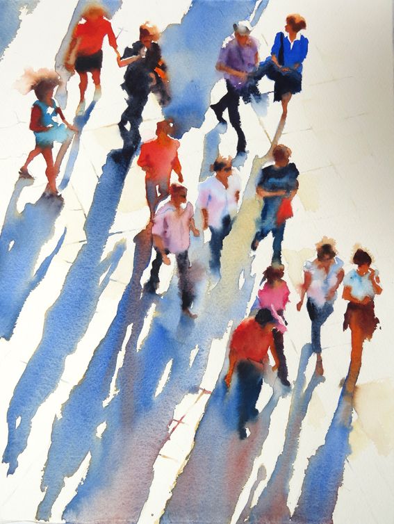 a group of people walking down a street next to each other