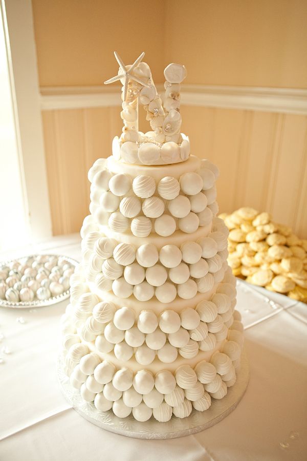 a wedding cake with white frosting and candies