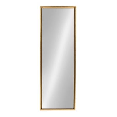 a gold framed mirror on a white wall