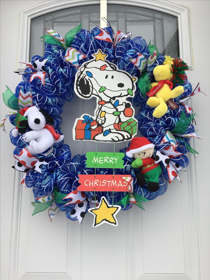 a blue wreath with a snoopy christmas decoration on it