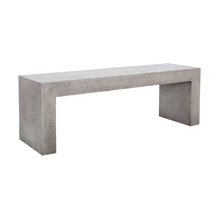 a concrete bench sitting on top of a white floor