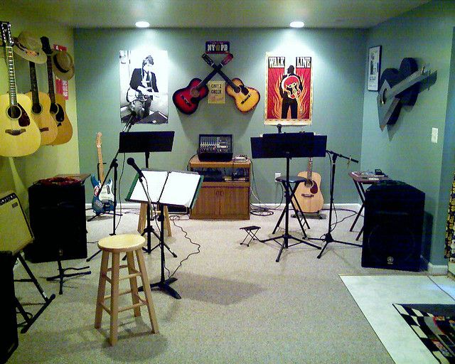 a room with guitars and music equipment in it