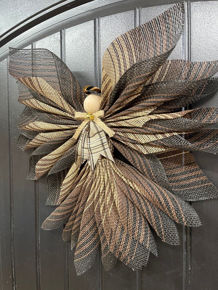 a metal door with a wreath made out of leaves on the front and side of it