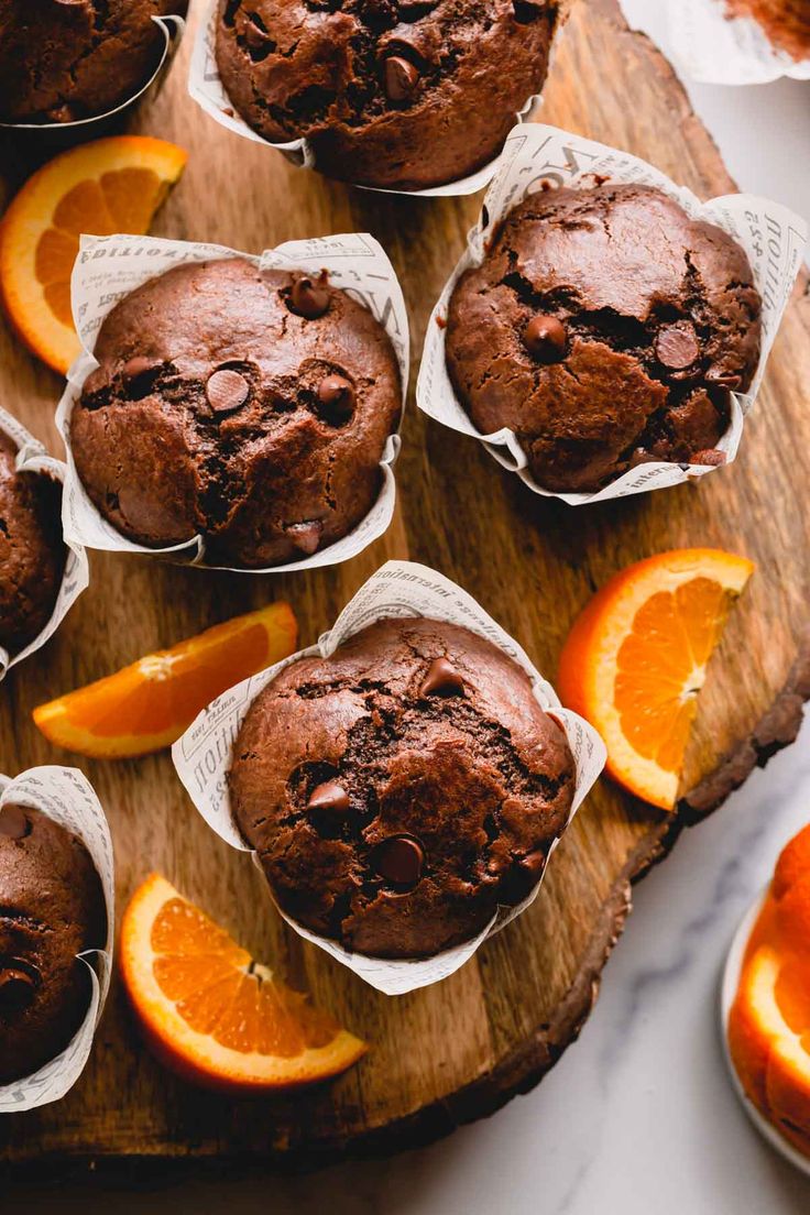 orange chocolate muffins on a wooden cutting board