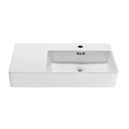 a white bathroom sink sitting on top of a counter next to a faucet