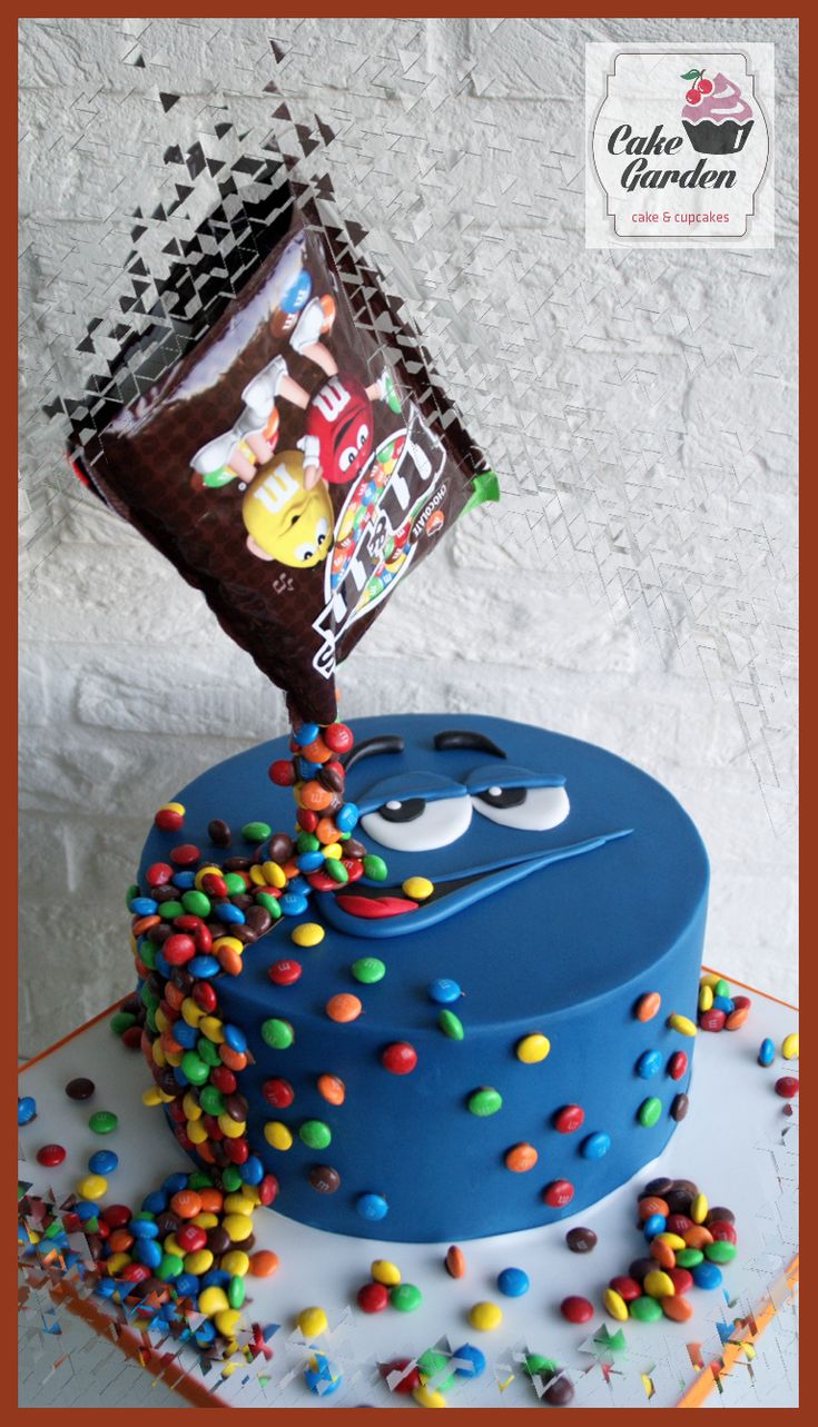 a blue cake with sprinkles on it and a bag of chocolate chips sticking out of the top