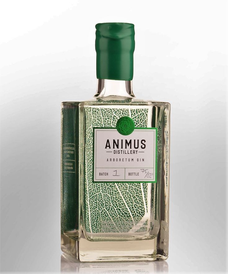 an empty bottle of gin with green cap on it's top and the word annus written in white