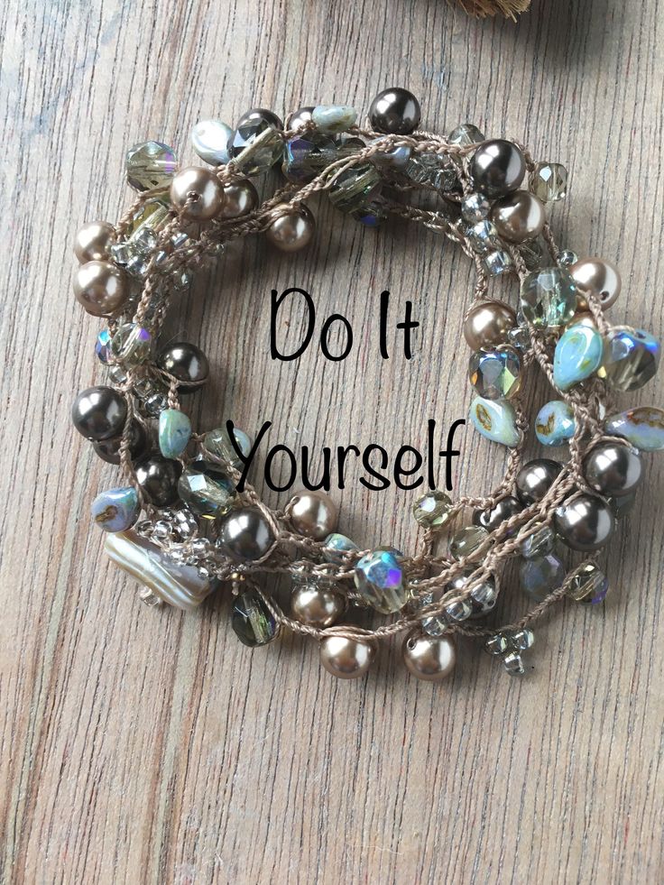 a close up of a bracelet on a wooden surface with the words do it yourself