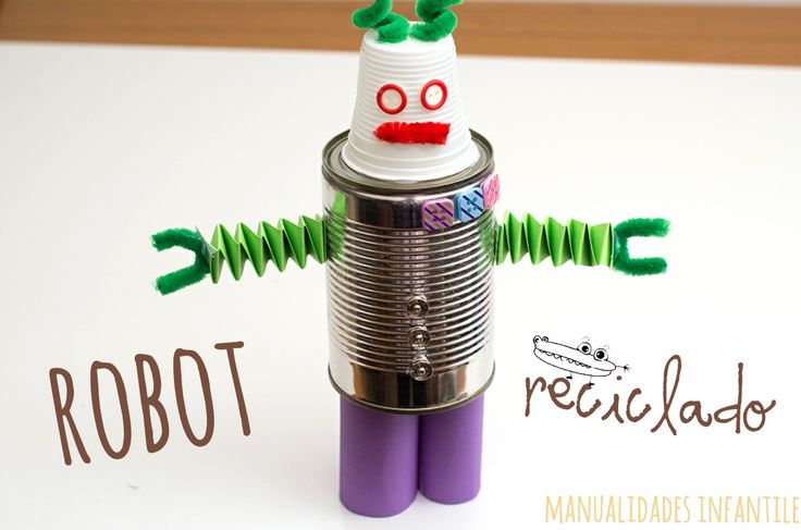 a robot made out of tin cans sitting on top of a white sheet of paper