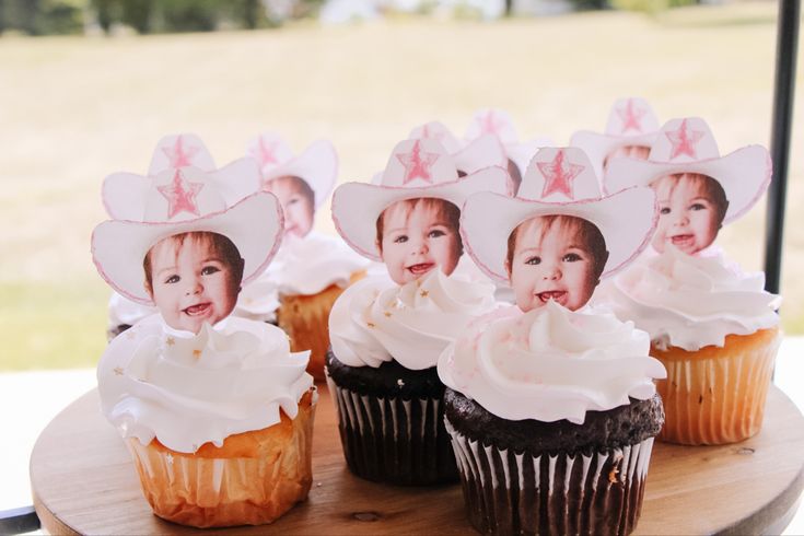 cupcakes with pictures of babies in hats on them